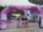 Three men with 'Walk Together, Embrace Bauhinia' banner at race finish