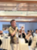 Jo Lodder delivering a high-performance keynote talk to an engaged corporate audience, focusing on resilience and team empowerment.